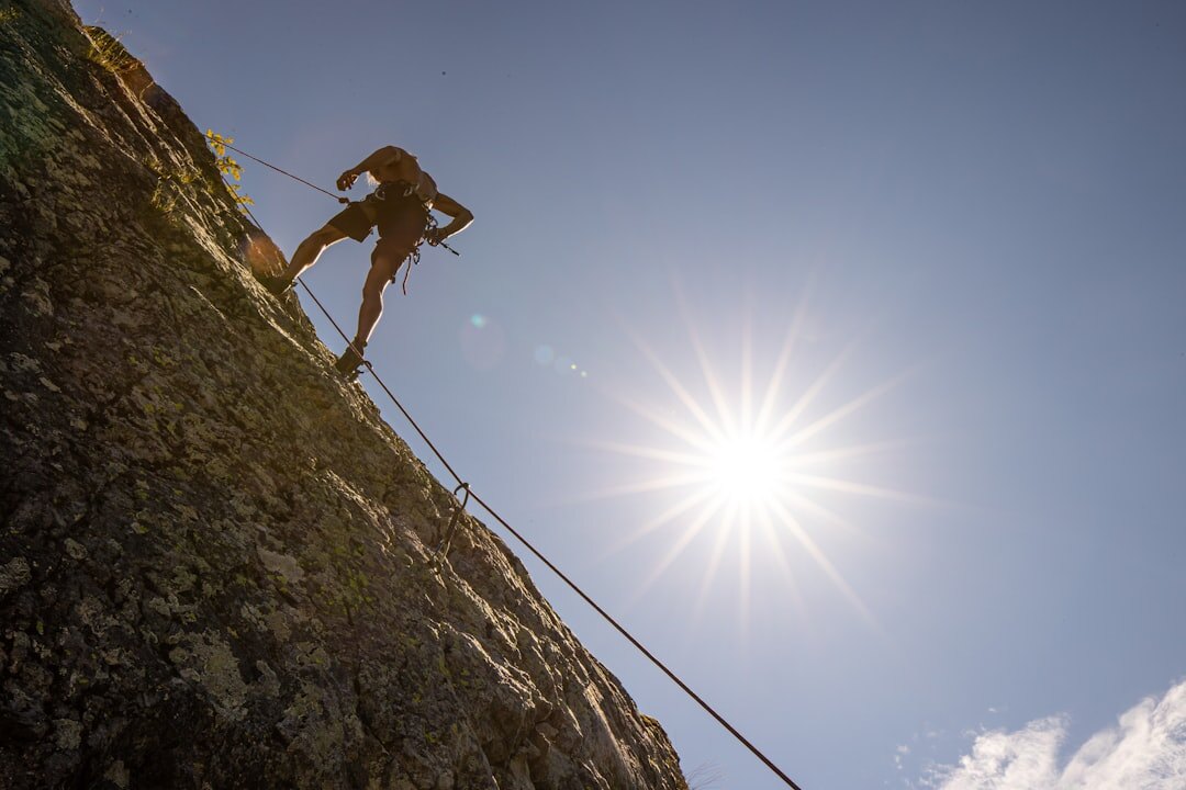 person climbing mountain