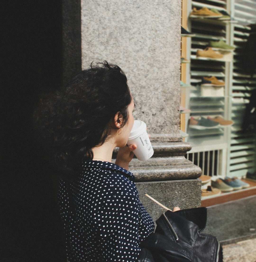 Woman sitting quietly by a window reflecting