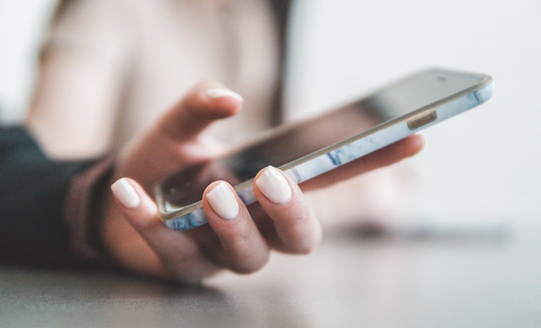 Close up of a hand typing a message on a smartphone