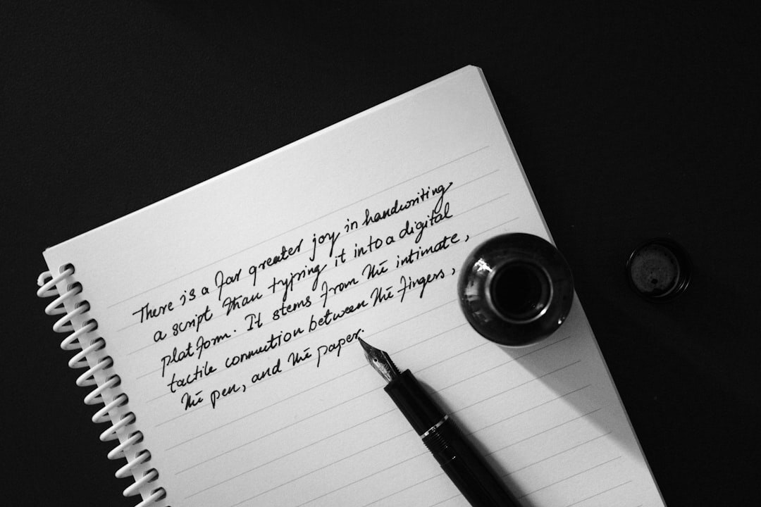 Open notebook with handwritten notes and a pen