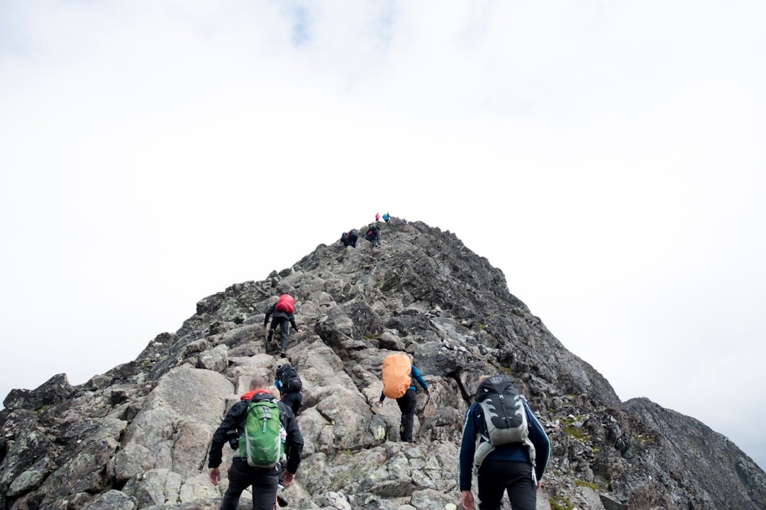 person climbing mountain